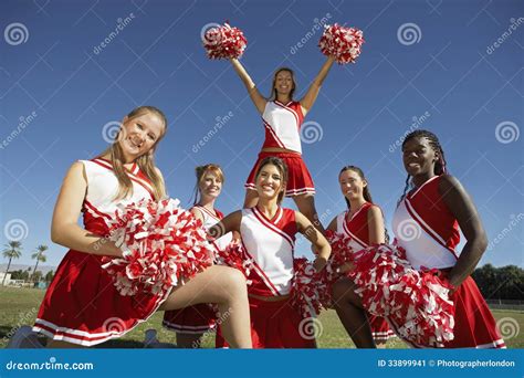 Happy Cheerleaders Holding Pompoms On Field Stock Image Image Of Holding Interracial 33899941