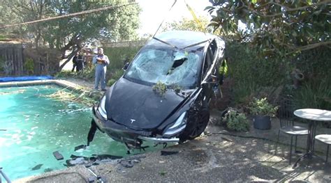 Horror pictures show aftermath after Tesla crashes through fence and ...