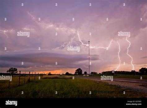 Cloud to ground and anvil crawling lightning bolts illuminate a decaying evening supercell ...