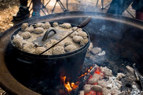 Dutch Oven Camp Cooking With Coal Briquettes Beads On Top Campfire In