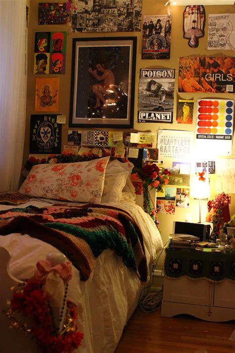 a bedroom with posters on the wall and bed