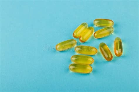 Vitamin D Yellow Pills On Blue Background Medicine Gel Tablets Of