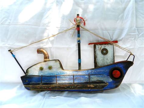 A Wooden Toy Boat Sitting On Top Of A White Sheet Covered Floor Next To