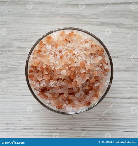 Himalayan Sea Salt In A Glass Bowl On White Wooden Background Top View