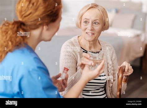 Focused Mature Woman Taking Required Medication Stock Photo Alamy