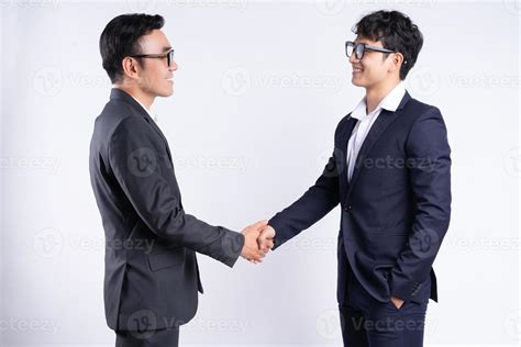 Two Asian Business Men Shaking Hands On A White Background 3122553