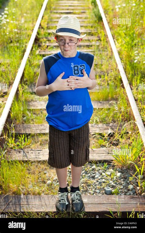 A Boy Making A Funny Face On Train Tracks Stock Photo Alamy