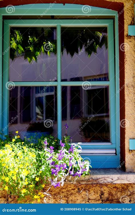 Tilted Window With Turquoise Frame And Cross And A Reflection Stock