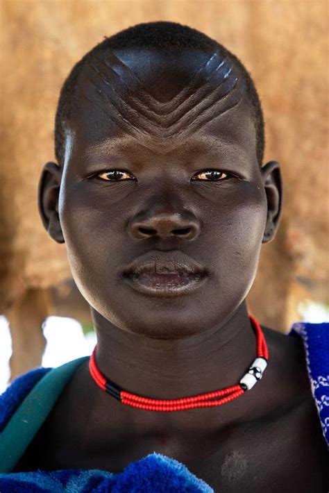 Portrait Of A Mundari Tribe Woman With Scarifications On The Forehead