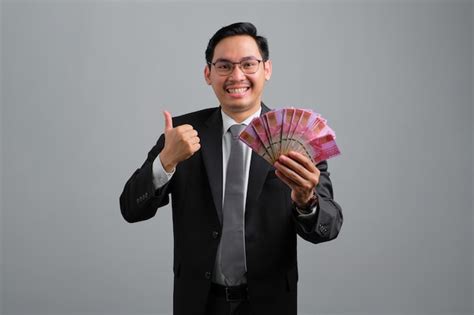 Premium Photo Portrait Of Cheerful Handsome Young Businessman In Formal Suit Showing Fan Of