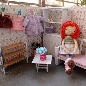 There Is A Doll House With Furniture And Dolls On The Floor In Front Of It