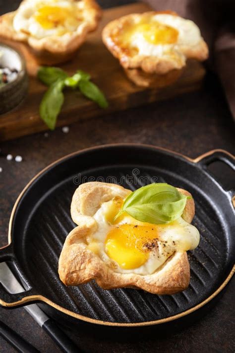 Scrambled Eggs In Puff Pastry With Cheese And Bacon On A Stone Plate