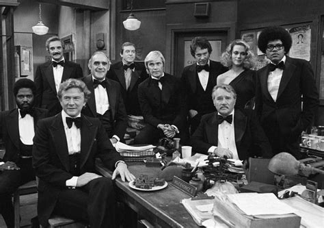 Black And White Photograph Of Men In Tuxedos Posing For A Group Photo