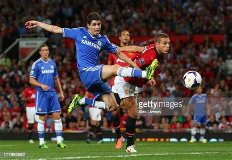 Oscar Of Chelsea Is Challenged By Nemanja Vidic Of Manchester United