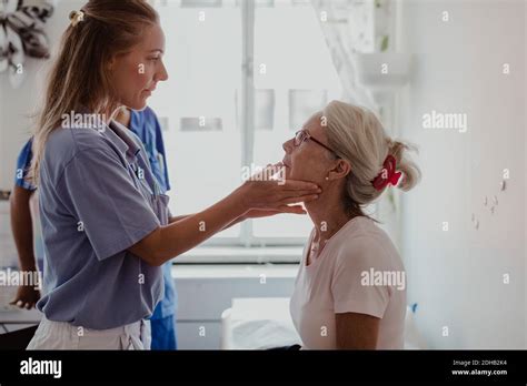 Mature Female Doctor Examining Patient S Throat In Medical Examination Room Stock Photo Alamy