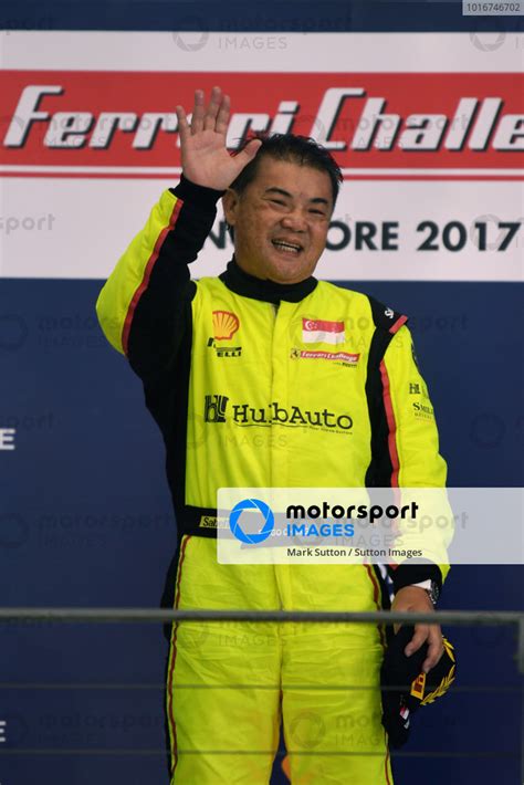 Race Winner Ringo Chong Sin Celebrates On The Podium At Ferrari