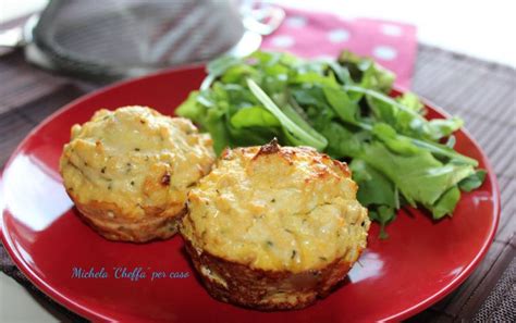 Two Muffins Sitting On Top Of A Red Plate Next To A Green Salad