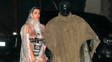 Bianca Censori Struggles To Protect Her Modesty Under A Sheer Raincoat