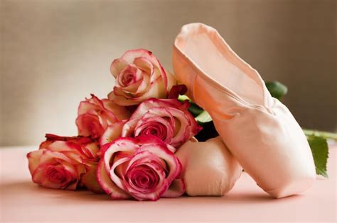 Premium Photo New Ballet Slippers Lying On Pink Background With Roses