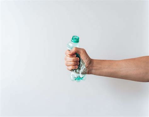 Hand Holding A Crumpled Plastic Bottle Free Stock Photo Picjumbo