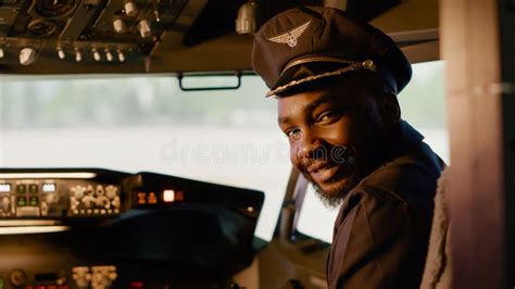 Portrait Of African American Copilot Helping To Fly Airplane Stock