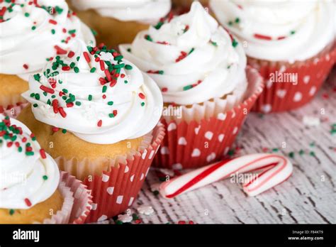 Christmas Cupcakes With Vanilla Frosting And Red And Green Sprinkles On