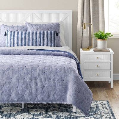 A Blue And White Bed In A Bedroom