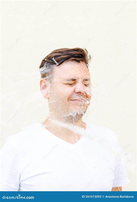 Wet Young Caucasian Man In White T Shirt With Closed Eyes In Water