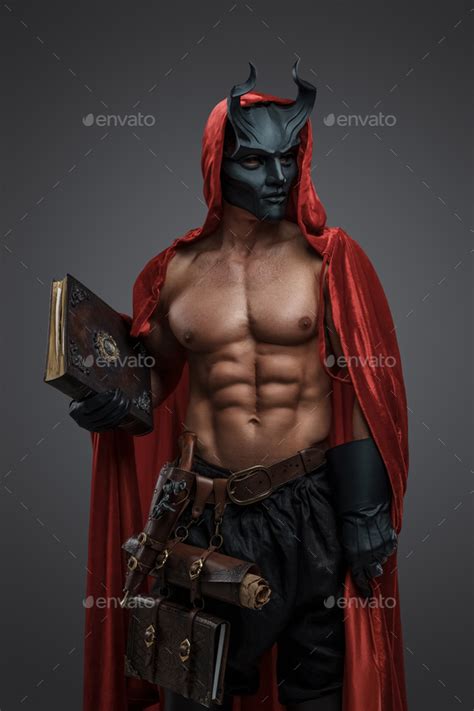 Dark Cultist With Naked Torso And Red Robe Holding Book Stock Photo By