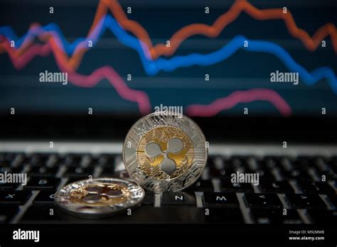 Ripple Cryptocurrency Coins Seen In Front Stock Market Graphs Stock