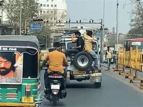 Two People Traveled By Sitting On The Spare Tire Of The Storm The