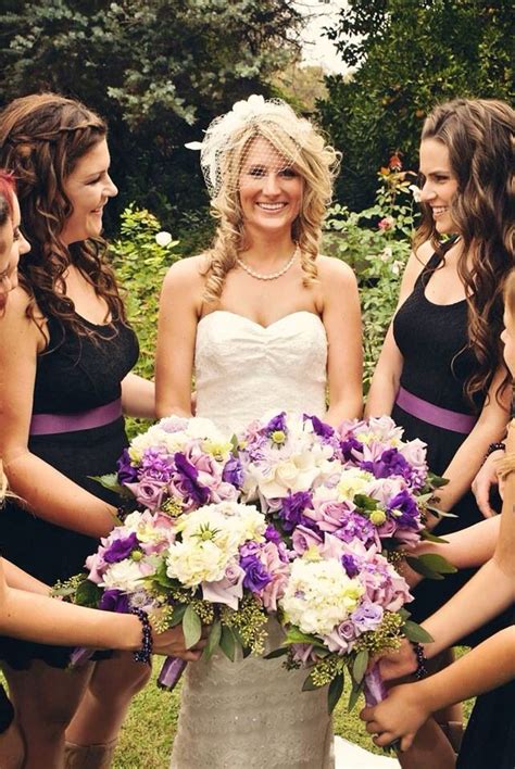 Bride And Bridesmaid Pose Looking At Bride And Showing Off The Bouquets