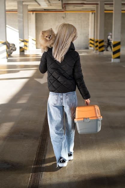 Free Photo Person Traveling With Their Pet And Carrier