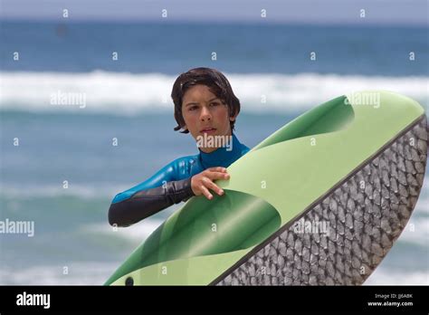 Young surfer boy and surfboard Stock Photo - Alamy
