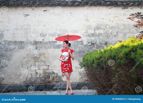 Happy Chinese Woman In Red Cheongsam Tour At Ancient Town Stock Image