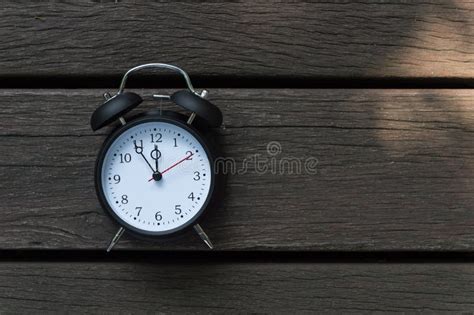 Retro Alarm Clock With Five Minutes To Twelve O Clock Stock Image