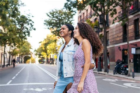 Lesbian Couple Walking Down The Street Holding Hands Free Photo 0JG7Mn Noun Project