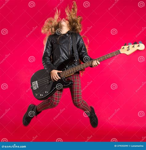 Blond Rock And Roll Girl With Bass Guitar Jump On Red Royalty Free ...