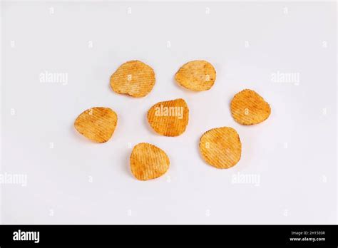 Potato Chips Falling Into Glass Bowl Isolated On White Background With