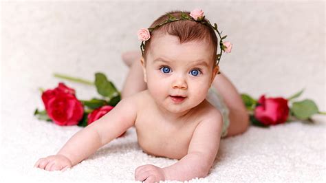 Blue Eyes Cute Little Girl Child Baby Is Lying Down On White Fur Cloth