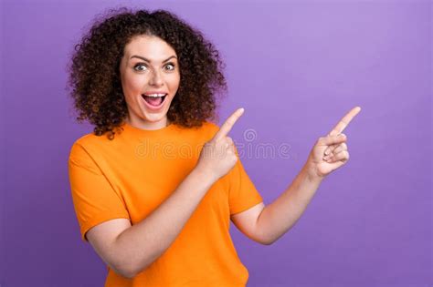 Photo Of Cheerful Impressed Lady Dressed Orange T Shirt Pointing Two