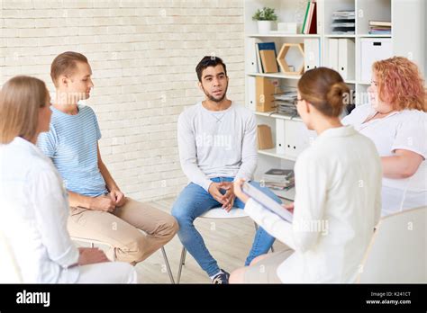 Young People In Group Therapy Session Stock Photo Alamy