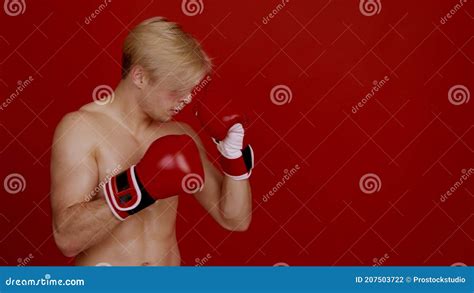 Boxing Side View Portrait Of Muscular Athlete With Naked Body Punching Hands In Boxing Gloves