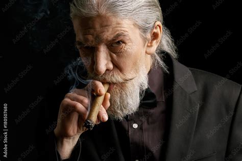 Stylish Old Man Smoking Cigar Aged Male In Black Suit In Studio 스톡 사진