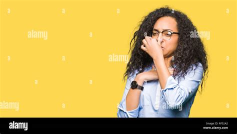 Young Beautiful Business Girl With Curly Hair Wearing Glasses Smelling