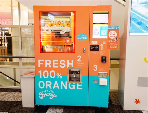 We Try Fresh Orange Juice Squeezed For Us By A Vending Machine In