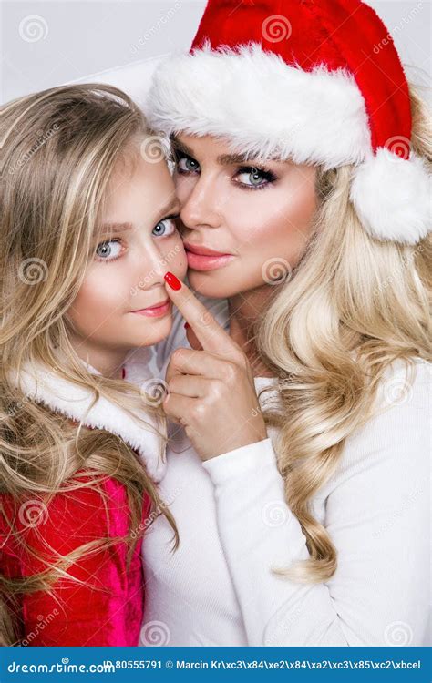 Beautiful Blonde Female Model Mother And Daughter Dressed As Santa