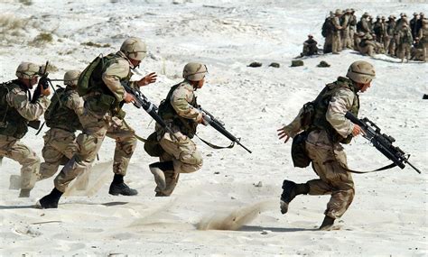 5 Soldiers Holding Rifle Running On White Sand During Daytime · Free