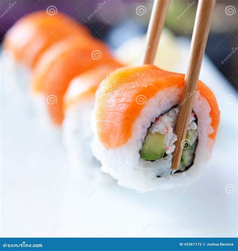 Picking Up A Piece Of Sushi With Chopsticks Stock Photo Image Of