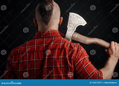 Rear View Of Bearded Man With Axe On Shoulder In Studio Stock Image